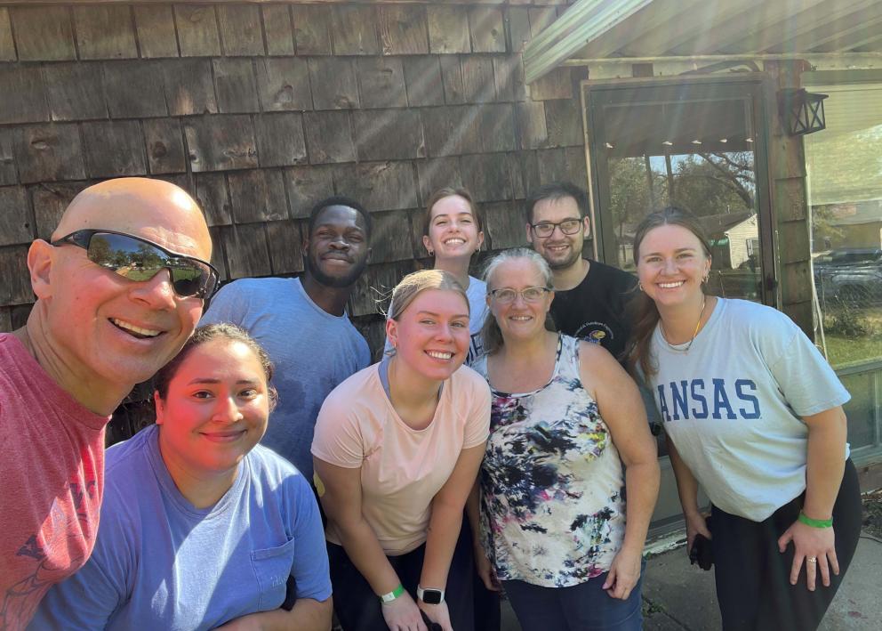 A group of people posing and smiling for a photo