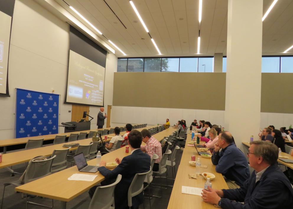 People attending a lecture in a large room