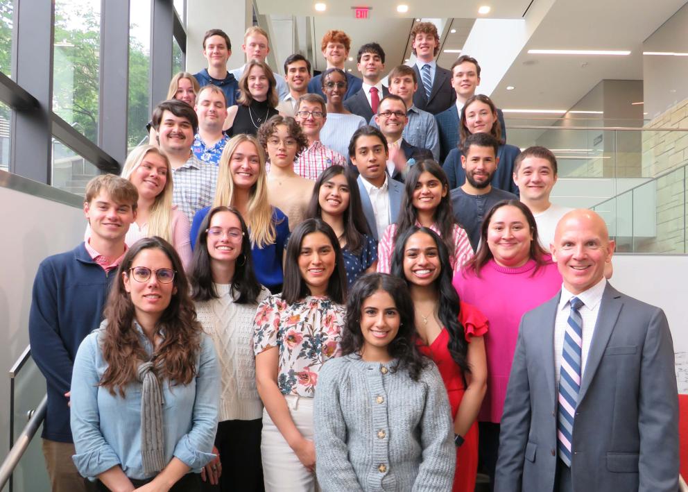 WISE undergrads and graduate students posing for a group photo on a staircase with Dr. Mark Shiflett and Dr. Ana Morais