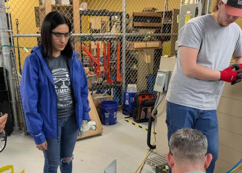 Students observing a demonstration with tanks of refrigerant