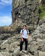 Emma Sage standing in front of a cliff wall